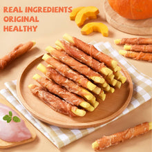 Chicken jerky wrapped pumpkin biscuit dog treats on round wooden board with sliced pieces.