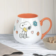 White ceramic mug with orange rim and handle and Peanuts Snoopy mother/baby hearts and flowers