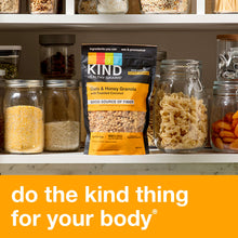 KIND Healthy Grains Oats & Honey Granola with Toasted Coconut bag on a store shelf.