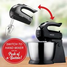 Black stand mixer with beaters raised above stainless steel bowl