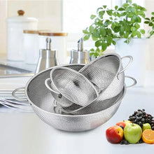 Stacked stainless steel perforated colanders with side handles for rinsing and draining
