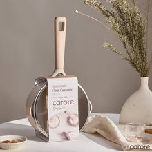Taupe ceramic nonstick saucepan with lid, shown with retail packaging