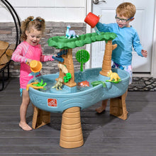 Toddler dino water table with blue basin, tree supports, and toy figures for splashing