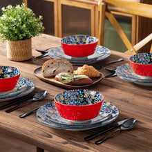Boho ceramic table setting with blue floral plates and red bowls