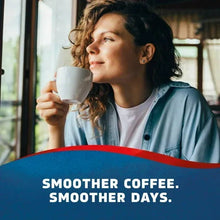 Woman holding a white coffee cup with Seattle’s Best Coffee branding