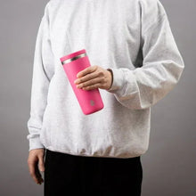 Bright pink insulated tumbler with clear straw, held in a hand