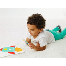 Child coloring with markers on a mess-free coloring page on the floor
