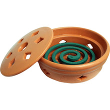 Orange terracotta mosquito coil burner with green teal spiraled coils and vented lid