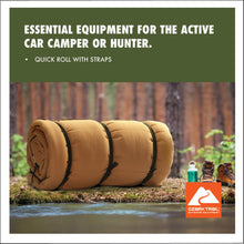Tan cold-weather sleeping bag, rolled cylinder shape with black carry straps