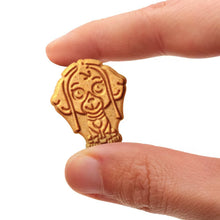Cinnamon graham cracker shaped cookie held between fingers