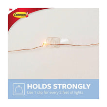 Clear Command clip holding a strand light wire on a wall