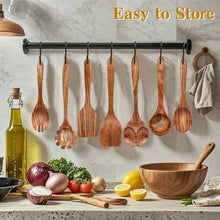 Wooden cooking utensils hanging on a rail, including spoons and spatulas