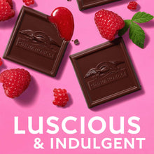 Dark chocolate squares with embossed logo and raspberry filling, with raspberries