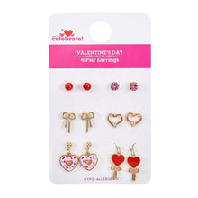 Earrings set on card with red studs, pink crystal studs, and heart charms