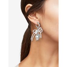 Silver-tone hoop earrings with bow charm and pearl-like bead dangle