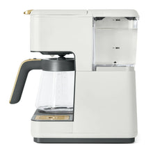 White drip coffee maker with transparent water reservoir and swing-open filter holder