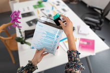 Ink cartridge document printing scene with hands holding printed pages over desk
