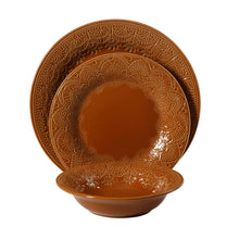 Caramel ceramic dinner plate with raised lace border and floral medallion center