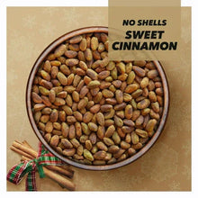 Bowl of sweet cinnamon pistachios, no shells, with cinnamon sticks