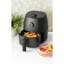 Black air fryer with open basket holding fries
