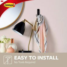 Wall-mounted double hook holding hanging items, matte black hook profile