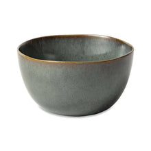Reactive ceramic serving bowl in dark teal with brown-gold rim
