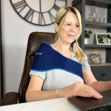 Blue shoulder and back compression wrap with padded curved panel and stitched border