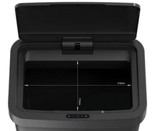 Open black automatic trash can lid revealing interior bin depth measurements