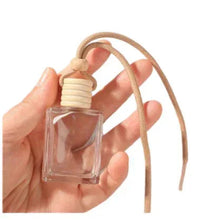 Hanging glass perfume bottle diffuser with beige cord loop and ribbed cap