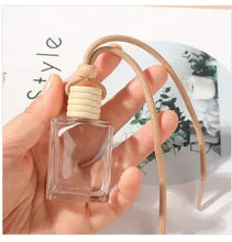 Hanging glass perfume bottle diffuser with beige rope cord and ridged stopper