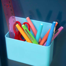 Assorted colored felt tip pens in a light blue plastic organizer