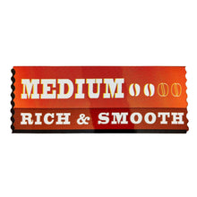 Medium rich & smooth coffee label strip on orange background.
