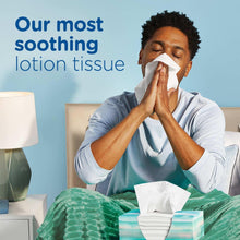 Puffs Plus Lotion facial tissue box with tissues being used