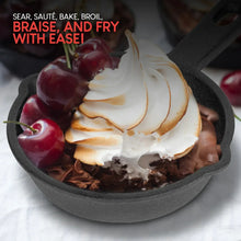 Mini cast iron skillet with a fried egg, chocolate dessert, and cherries