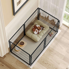 Black metal wire dog kennel with cushioned mat and feeding bowl, resting dog.