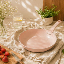 Blush pink ceramic non-stick fry pan with short handle, empty interior