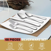 Stainless steel spoons and forks arranged on a rectangular serving tray