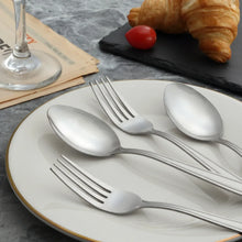 Stainless steel soup spoons and salad forks with mirror-polished reflective finish