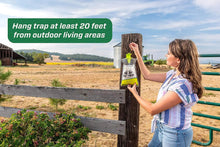Big bag fly trap hanging from fence post with green funnel top and mesh bag