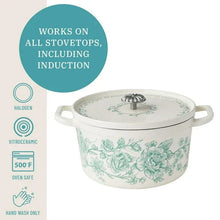 Light green floral enameled Dutch oven with domed lid and side handles