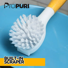 Bamboo-handled dish scrub brush with a white bristle head and dense bristles