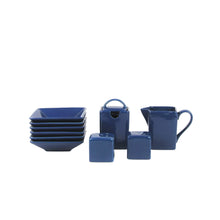 Dark blue square stoneware dinnerware set with stacked plates, mugs, and small cups