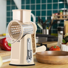 Beige rotary cheese grater with 5-blade drum, handle, and blade storage compartment