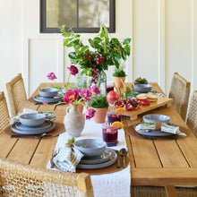 Grey round dinner plates on table, with swirled stoneware design
