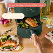 Air fryer with thyme green body, open basket with cooked food, gold handle