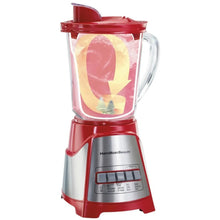 Red blender with clear jar filled with light yellow chunks and other ingredients