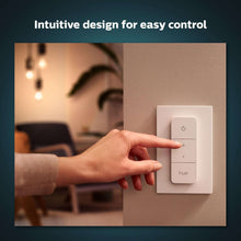 White Philips Hue dimmer switch with three buttons on a wall plate