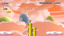 Platform game scene with Mario on a green pipe platform above clouds in a sunset sky