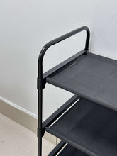 Black metal organizer frame with top and middle black fabric shelves for storage