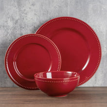 Red stoneware dinnerware set: large plate, smaller plate, and matching bowl